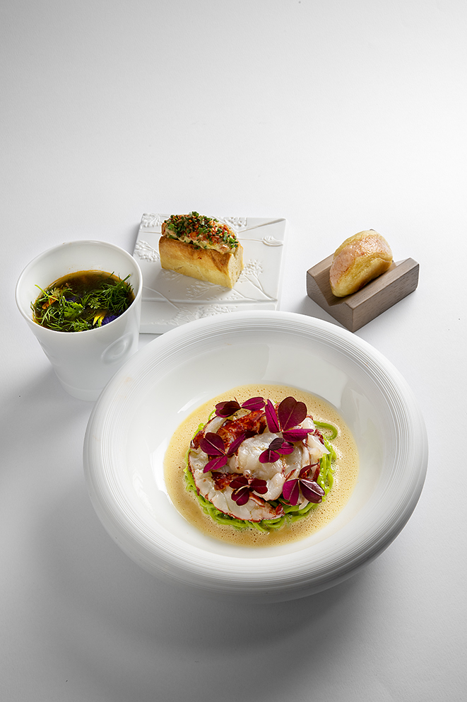 Homard breton cuit dans une cona sur des pâtes au basilic, beurre aux crustacés, bouillon aux herbes, bun’s et lobster roll